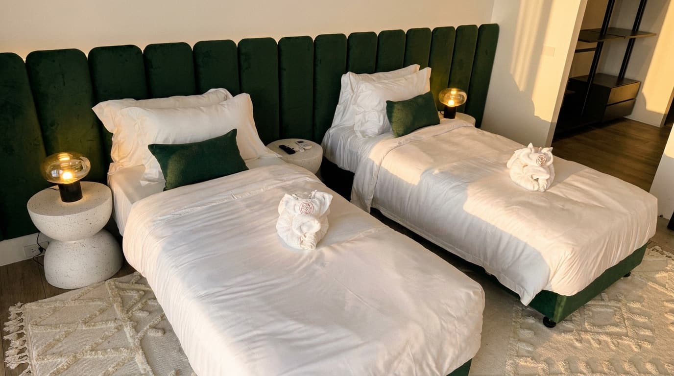 The third bedroom set as two single beds that combine into a king.