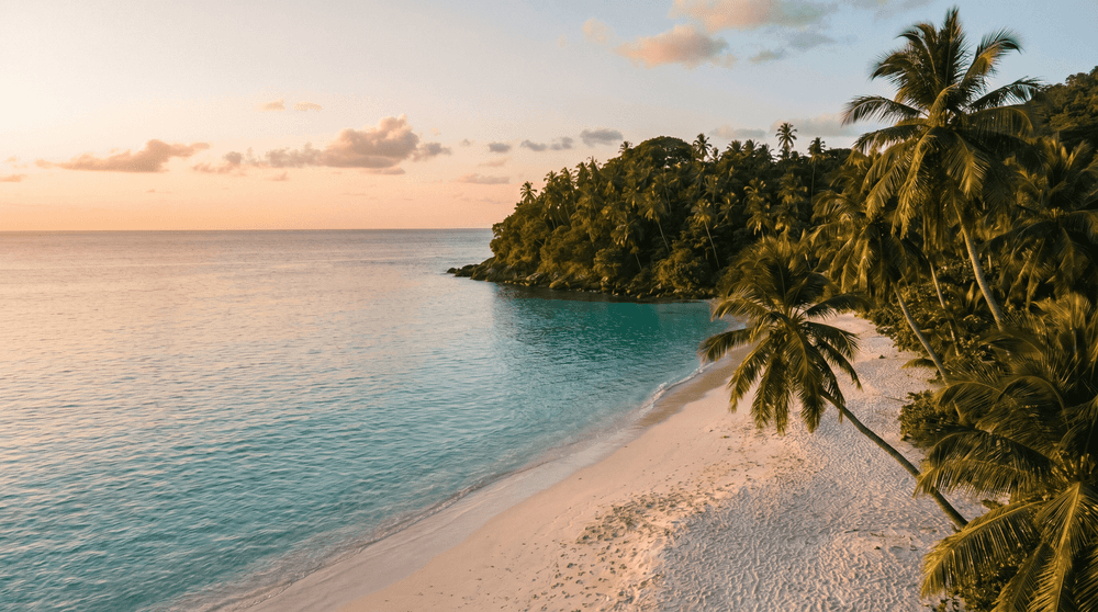 Golden-hour view of Chaweng Noi beach, calm turquoise water and a palm-covered headland